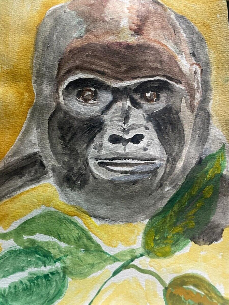 Watercolor portrait of a gorilla with brown eyes looking directly at the viewer, on a golden yellow background with green leaves, by Barbara Ballard